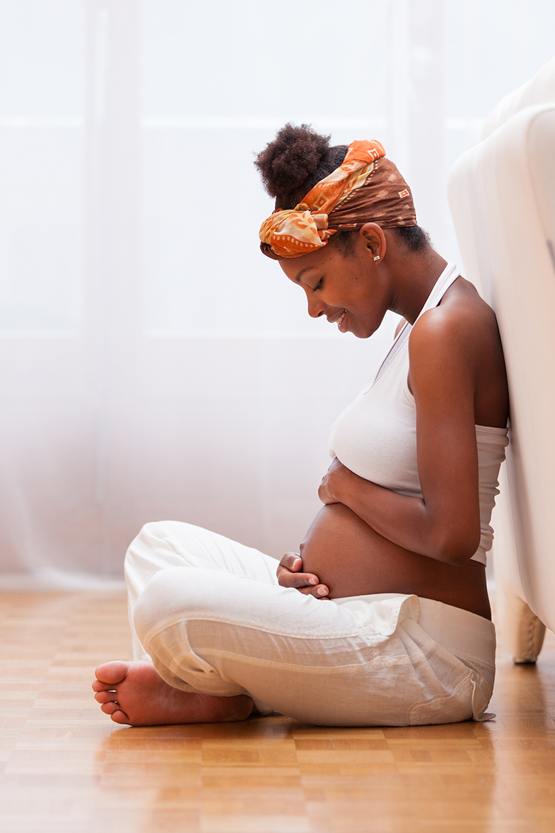 Pregnant woman touching her belly